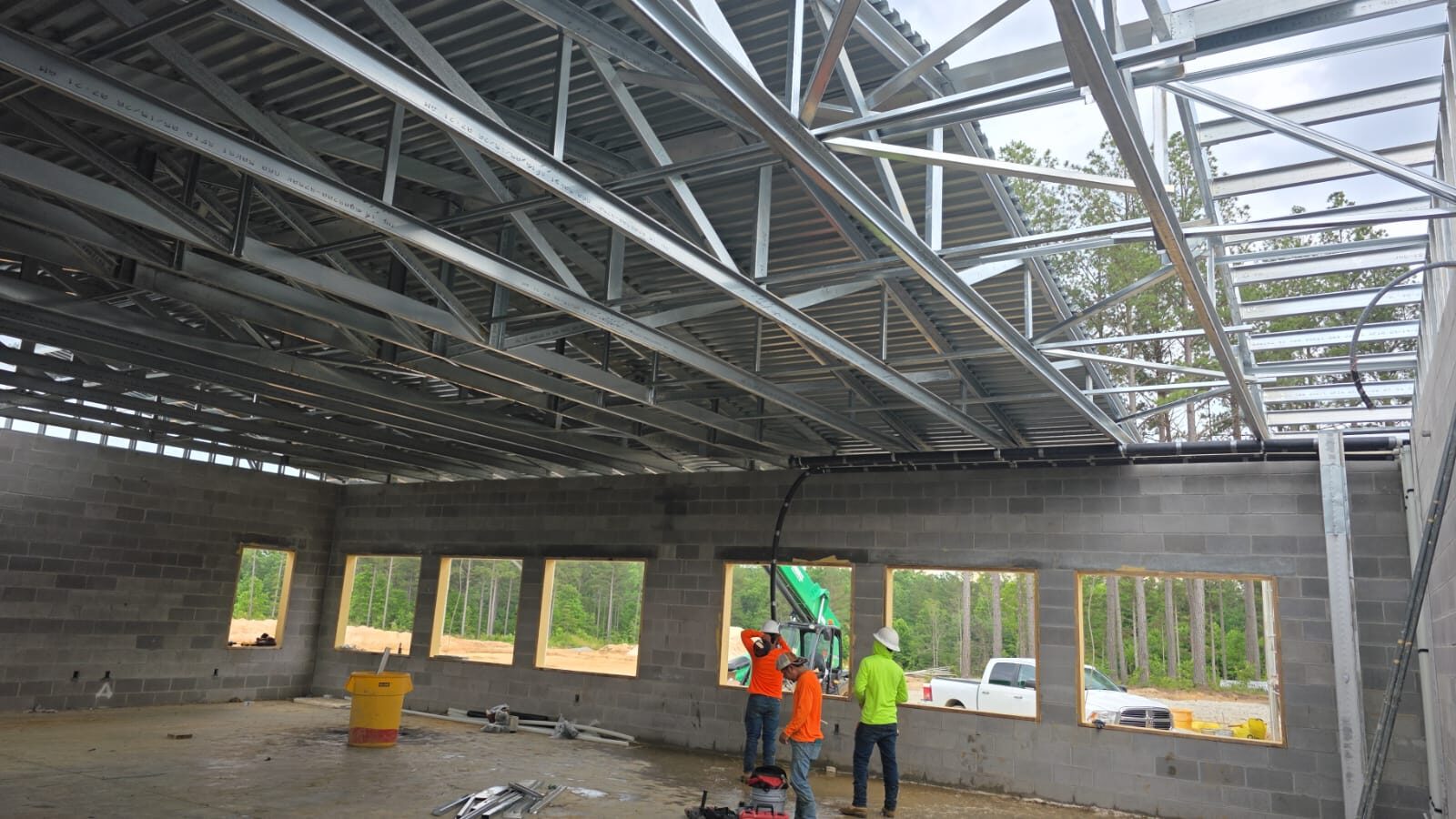 Truss crew installing metal roof decking on Part C